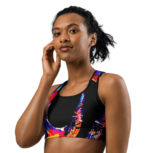 Woman wearing the 'HOOK' Sports Bra, featuring a vibrant abstract design in neon colors for style and comfort.